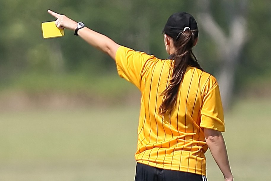Referee showing yellow card